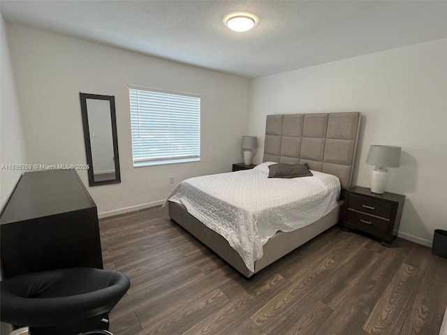 bedroom with dark hardwood / wood-style floors