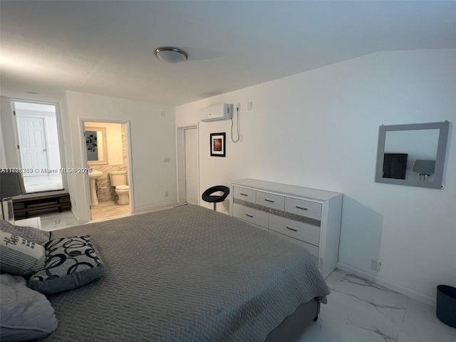 bedroom featuring ensuite bath and a wall mounted AC