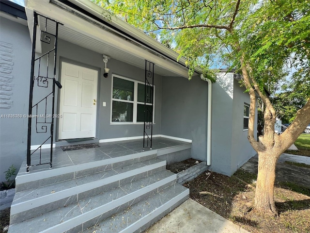 view of exterior entry featuring a porch