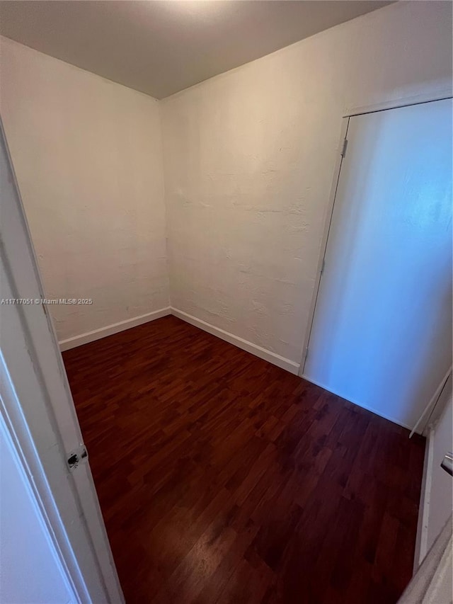 spare room featuring dark hardwood / wood-style floors