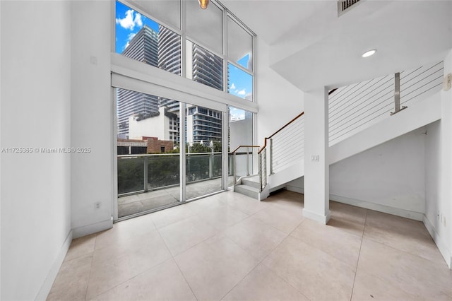 interior space featuring a towering ceiling and plenty of natural light