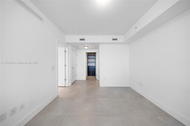 unfurnished room with light tile patterned floors