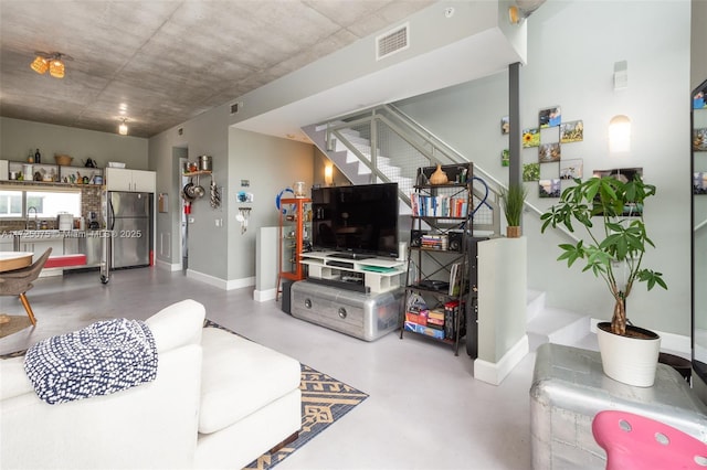 living room with sink and concrete floors