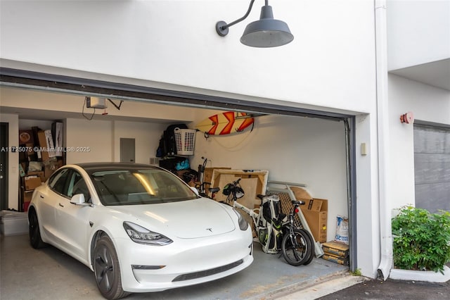 garage featuring electric panel and a garage door opener