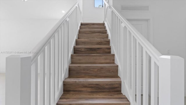 staircase featuring hardwood / wood-style floors