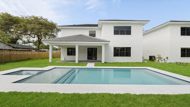 back of property with a yard, a fenced in pool, a patio area, and central AC unit