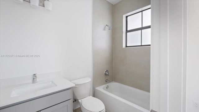 full bathroom with tiled shower / bath combo, vanity, and toilet