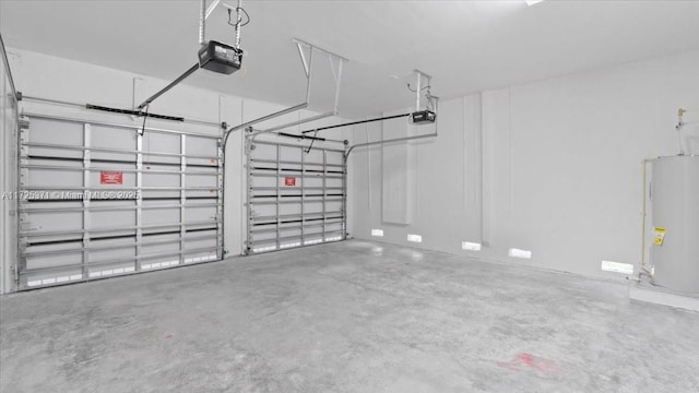 garage with water heater and a garage door opener