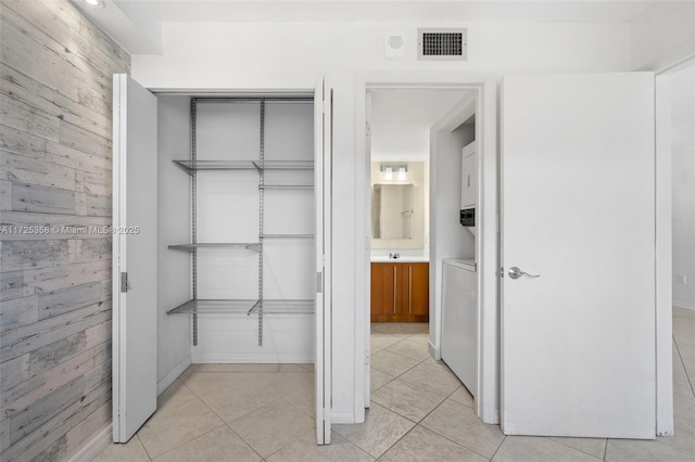 closet with stacked washer / dryer