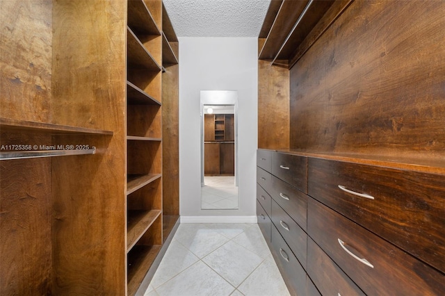 spacious closet with light tile patterned flooring