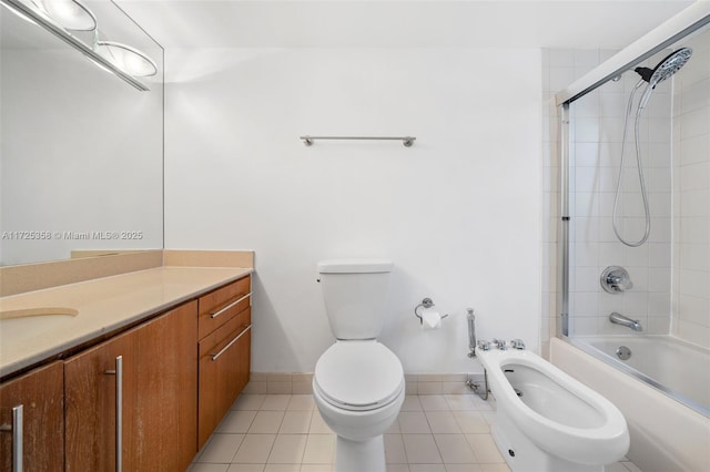 full bathroom featuring a bidet, combined bath / shower with glass door, toilet, tile patterned floors, and vanity