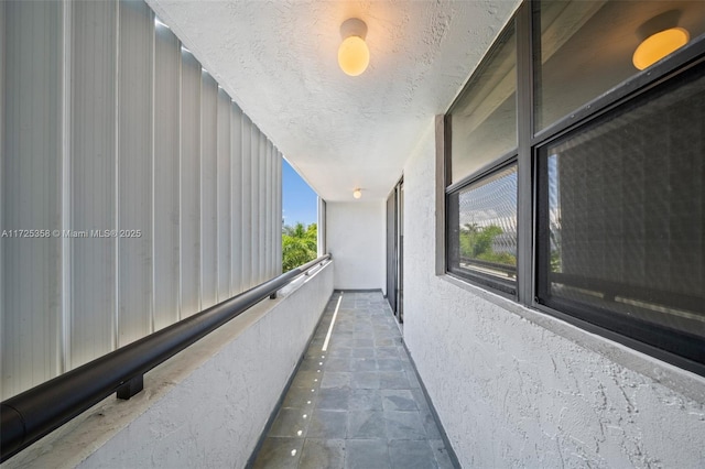 hallway with a textured ceiling