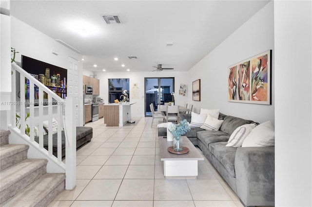 tiled living room featuring ceiling fan