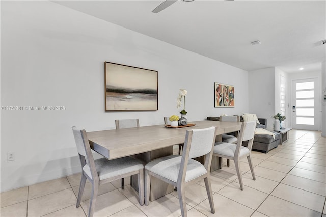 tiled dining space with ceiling fan