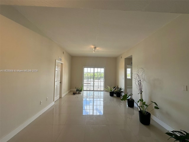 spare room featuring light tile patterned flooring