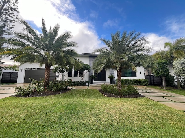 view of front of house featuring a front yard and a garage