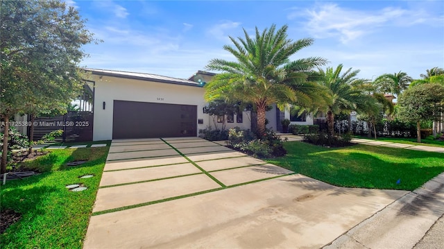 view of front of house featuring a front yard and a garage