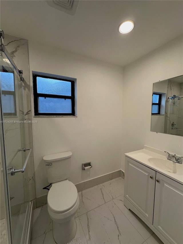 bathroom with toilet, an enclosed shower, and vanity