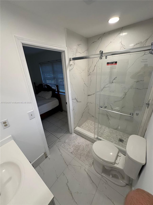 bathroom with toilet, a shower with door, and vanity