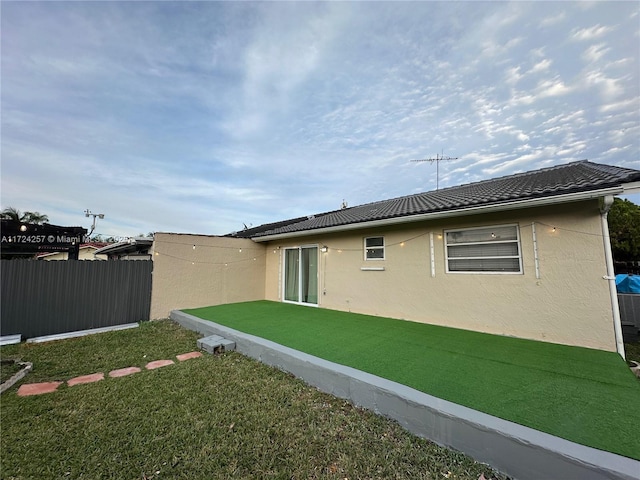 back of house featuring a yard