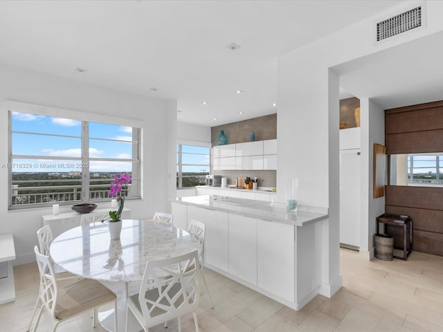 kitchen with kitchen peninsula and white cabinetry