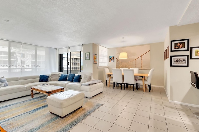 tiled living room featuring a textured ceiling