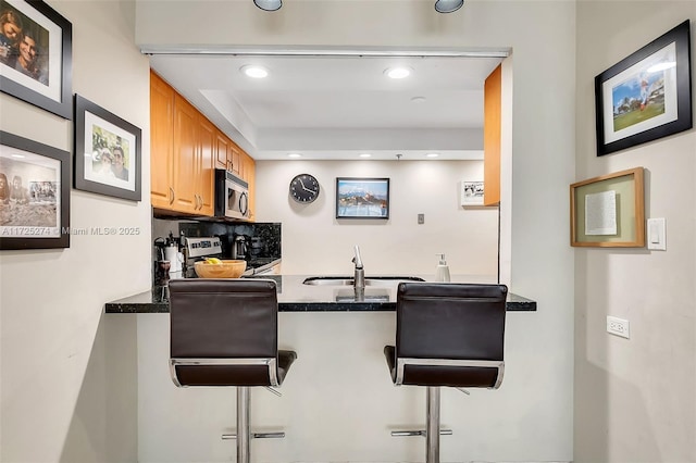 bar featuring stainless steel appliances and sink