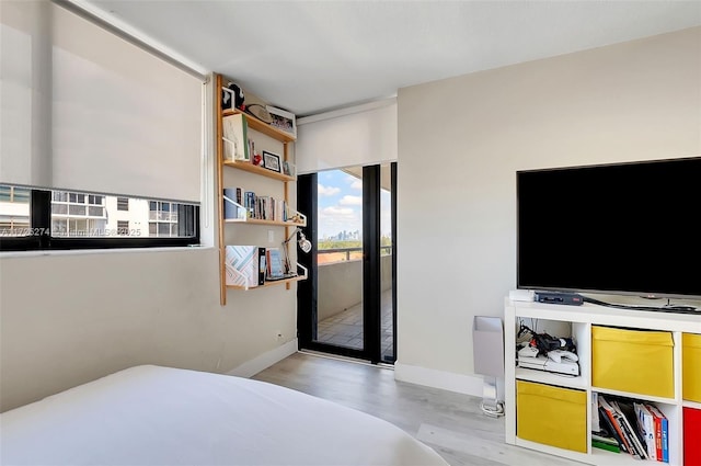 bedroom featuring light hardwood / wood-style flooring and access to exterior