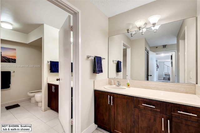 bathroom featuring a textured ceiling, vanity, a bidet, and tile patterned floors