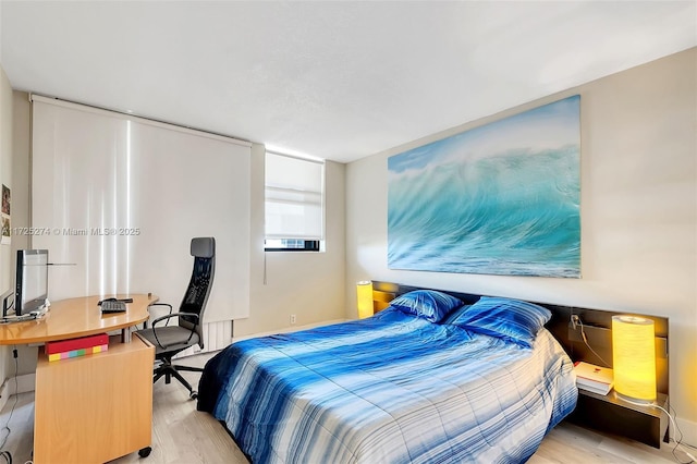 bedroom with light hardwood / wood-style flooring