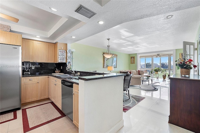 kitchen featuring kitchen peninsula, light brown cabinetry, light tile patterned floors, appliances with stainless steel finishes, and sink