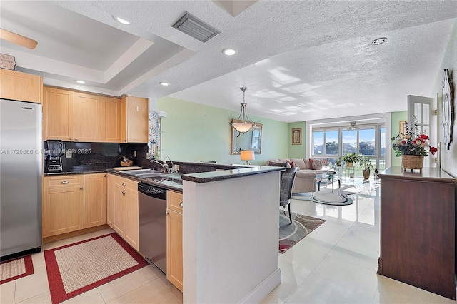 kitchen featuring stainless steel appliances, kitchen peninsula, light brown cabinets, sink, and light tile patterned flooring