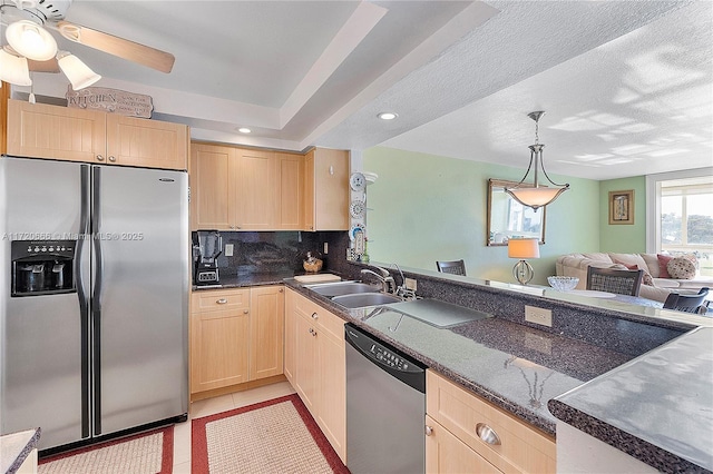 kitchen with appliances with stainless steel finishes, sink, and light brown cabinets