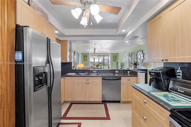 kitchen with stainless steel appliances, light brown cabinetry, light tile patterned floors, and sink