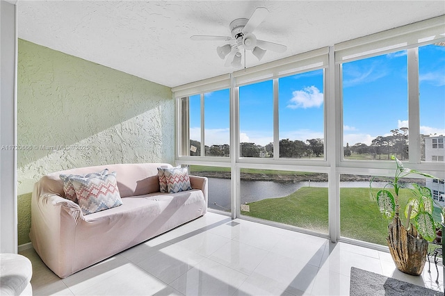 sunroom / solarium featuring ceiling fan