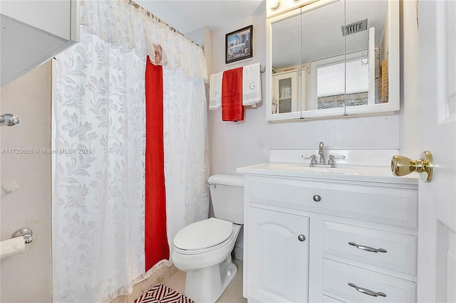 bathroom with toilet and vanity