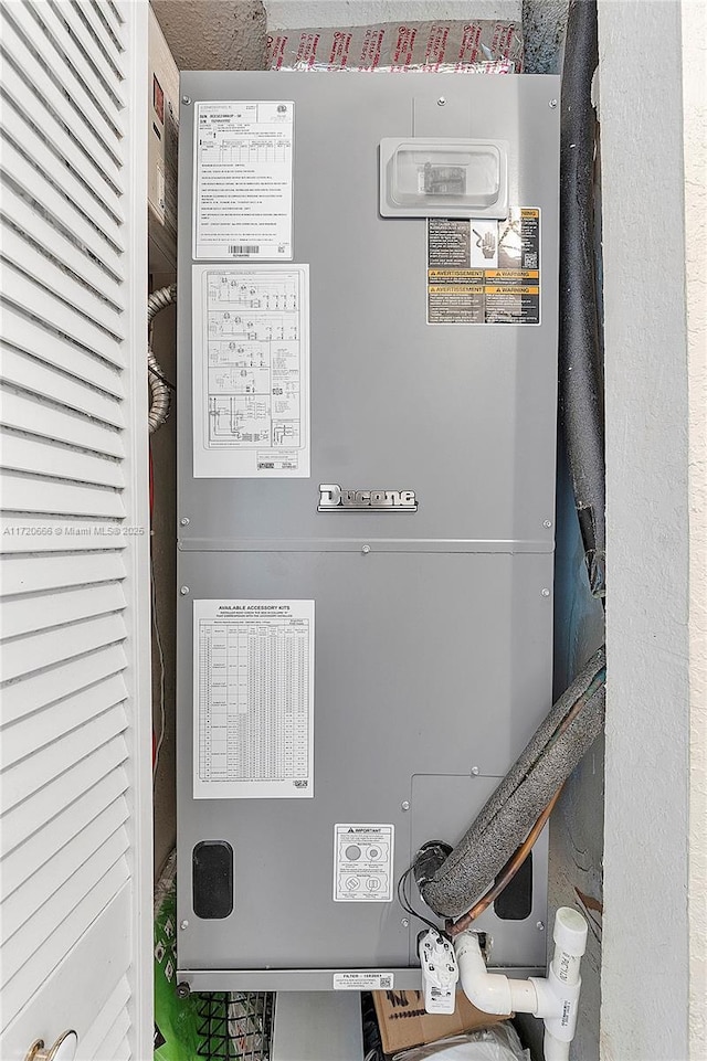 utility room featuring heating unit