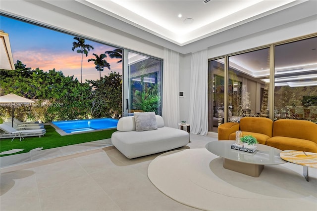 interior space with tile patterned flooring and a raised ceiling