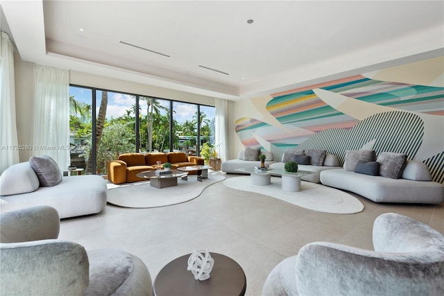 living room with a raised ceiling and plenty of natural light