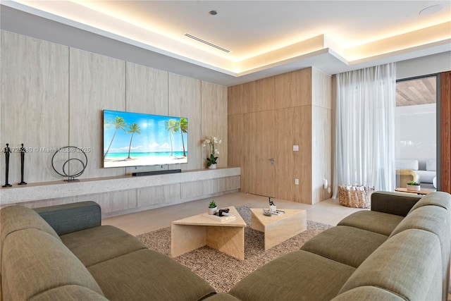 tiled living room with a raised ceiling and wooden walls