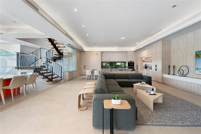 living room featuring a raised ceiling