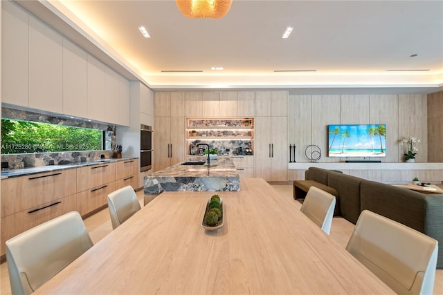 dining room featuring sink and wood walls