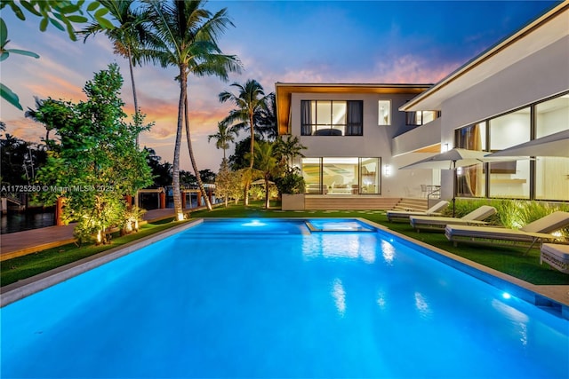 view of pool at dusk