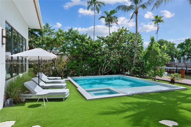 view of swimming pool featuring a lawn and an in ground hot tub