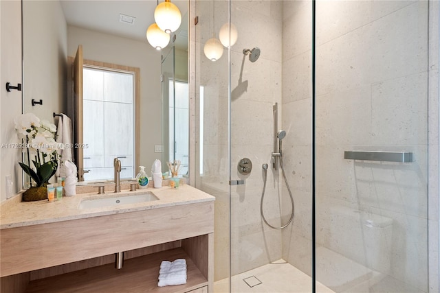 bathroom featuring vanity and a shower with shower door