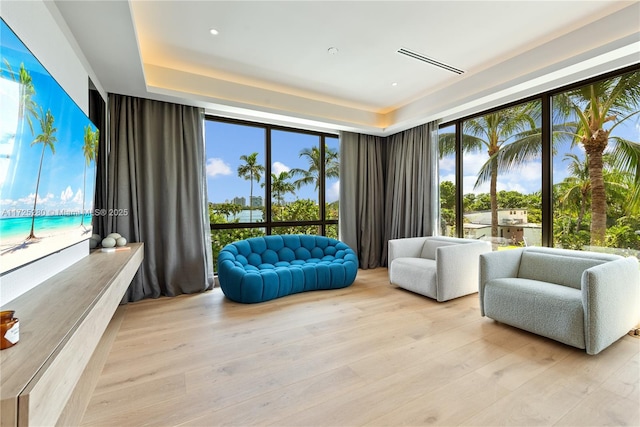 sitting room featuring light hardwood / wood-style floors and floor to ceiling windows