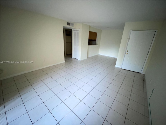 unfurnished room featuring light tile patterned floors