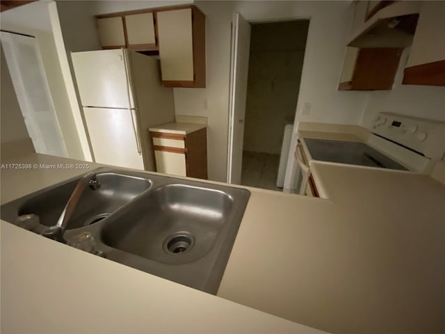 kitchen with white appliances and sink