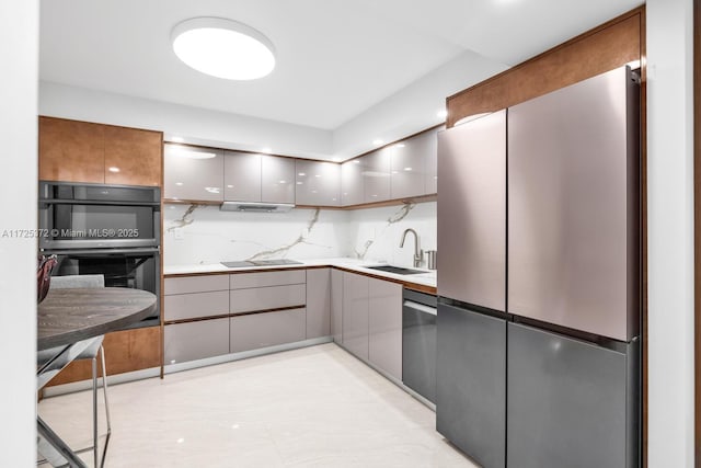 kitchen with stainless steel appliances, gray cabinets, tasteful backsplash, and sink