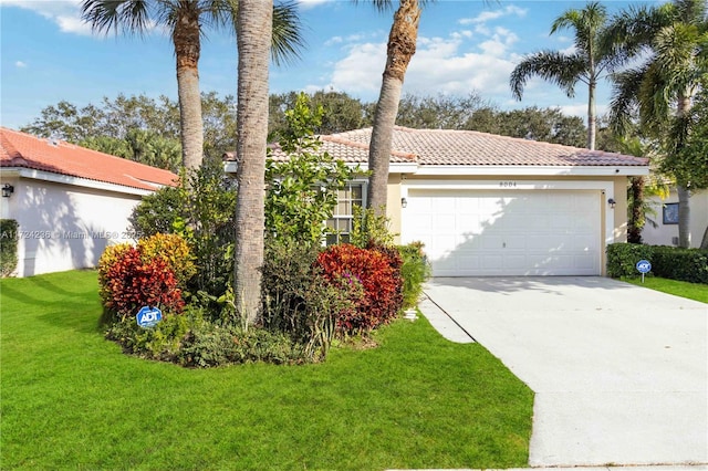 view of front of property featuring a front yard and a garage